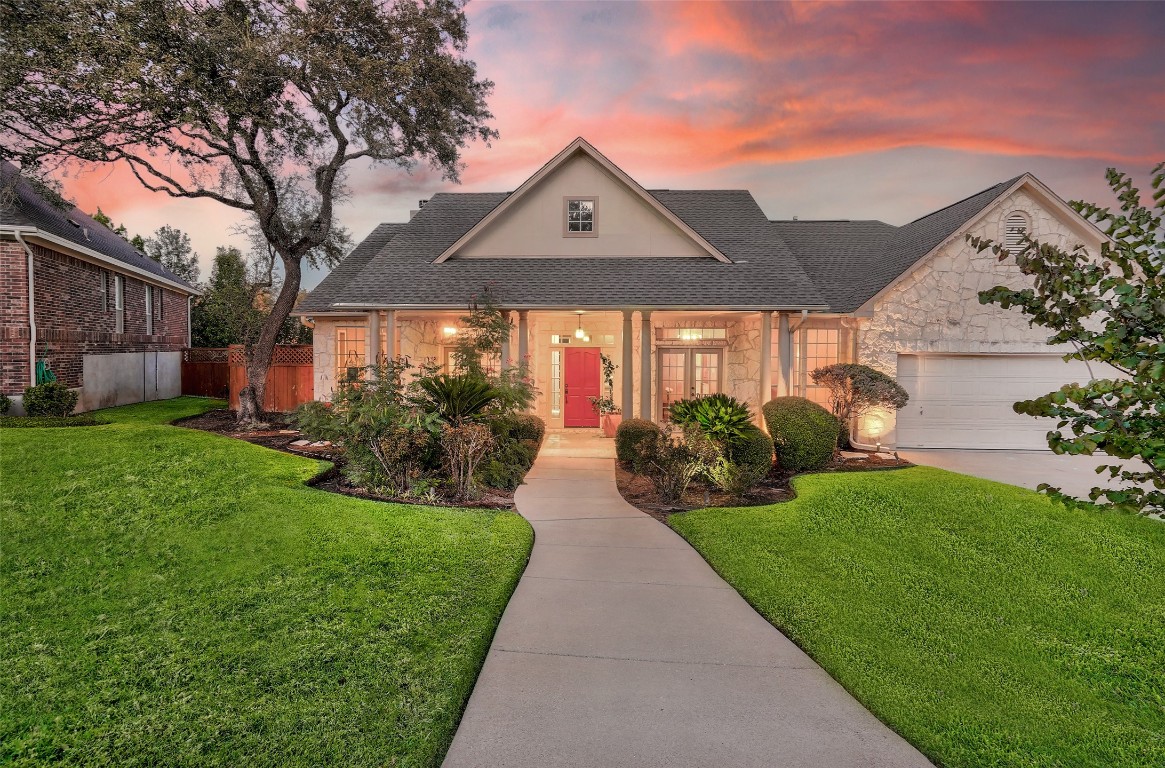 a front view of house with yard and green space