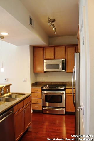 a kitchen with a stove microwave and sink