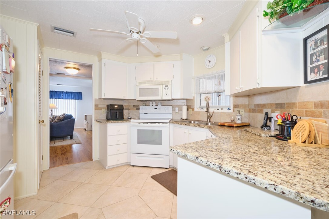 a kitchen with a stove a sink and a refrigerator