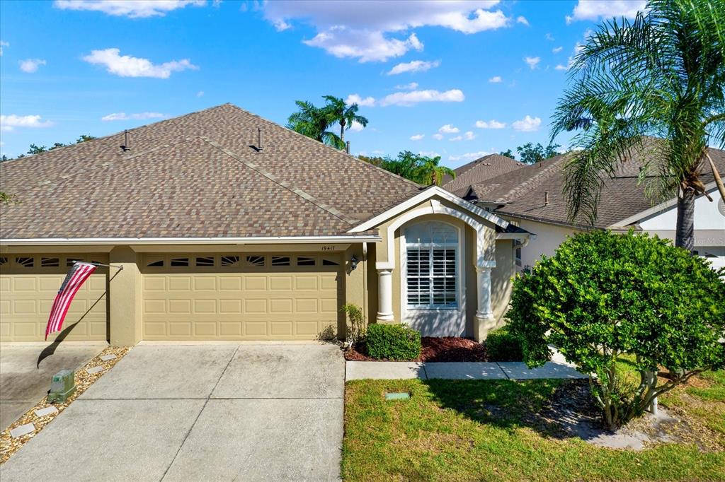 a front view of a house with a yard and garage