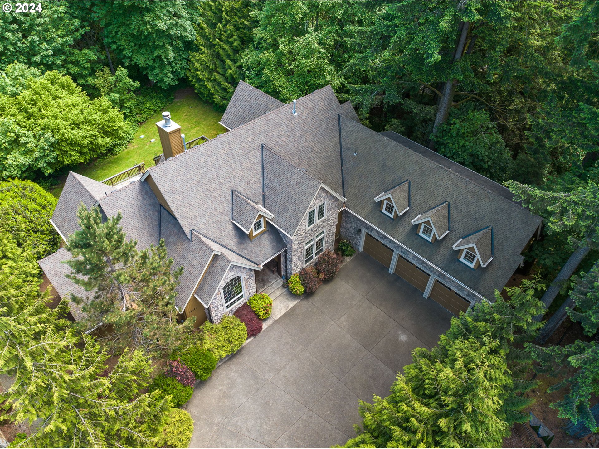 an aerial view of a house with outdoor space and street view