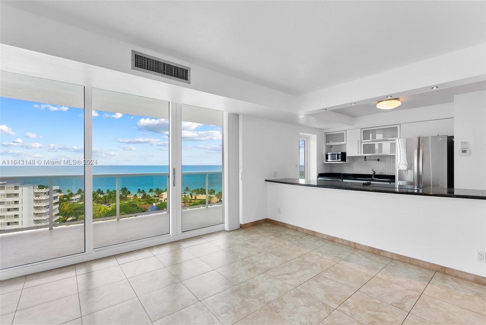 a large white kitchen with a large window