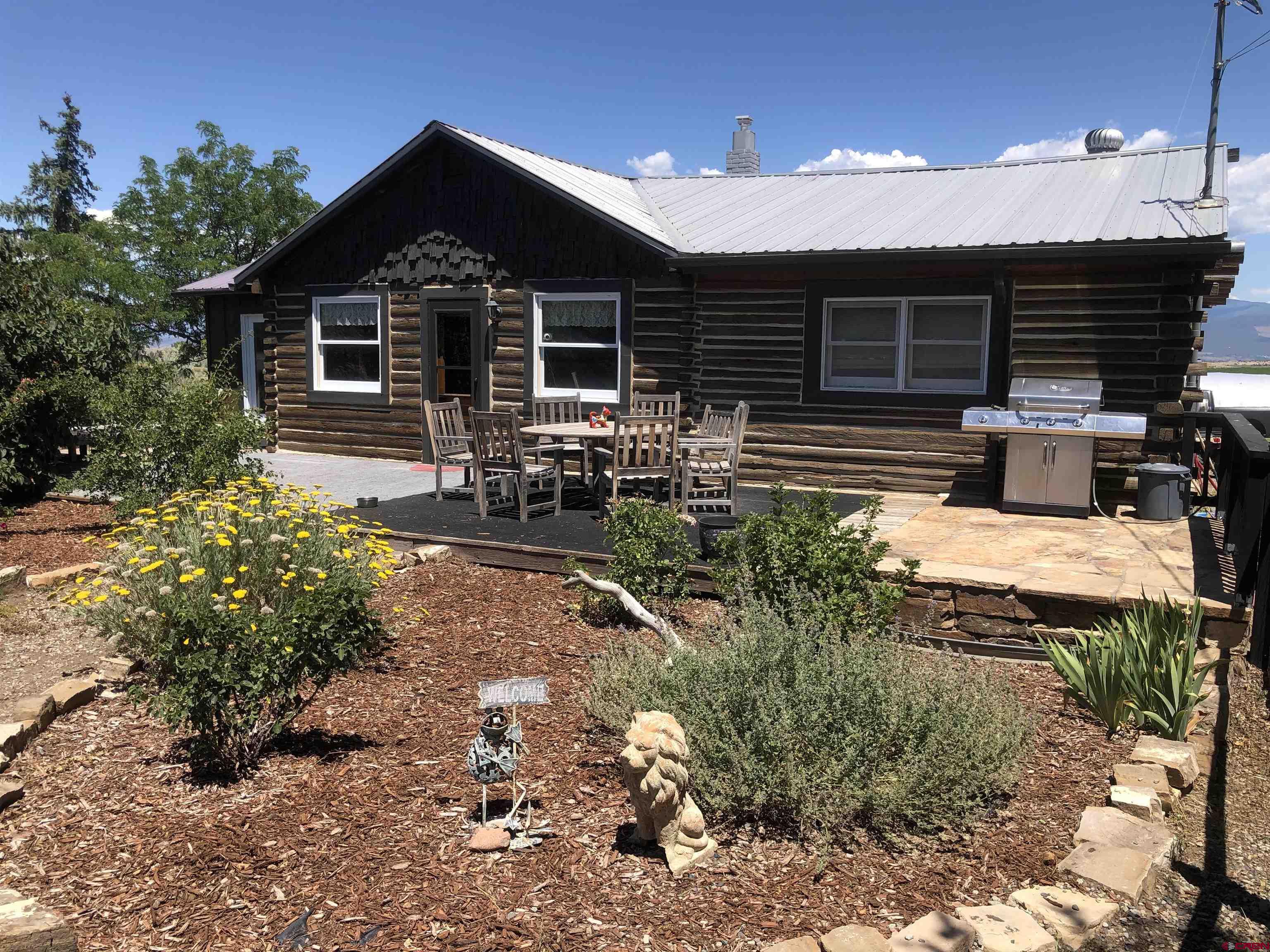 a view of a house with yard and sitting area