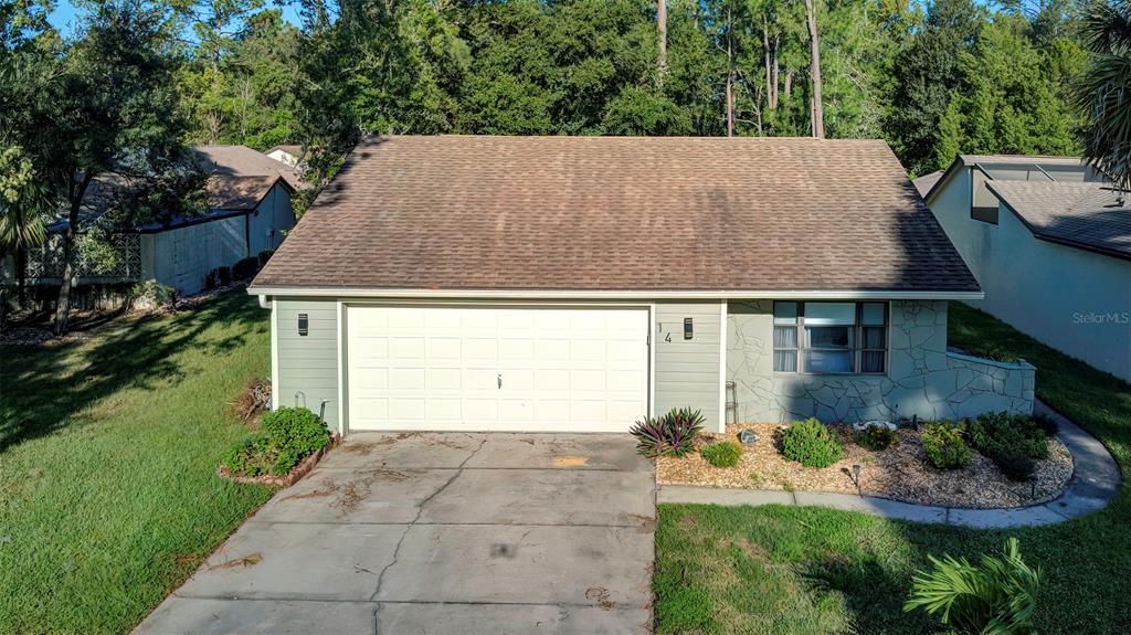 a view of a house with a yard and garage