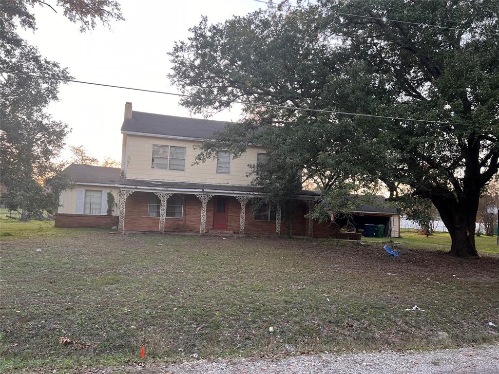 a view of a house with a tree in front of it