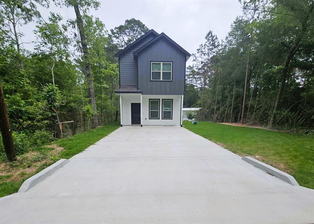 a front view of a house with yard and green space