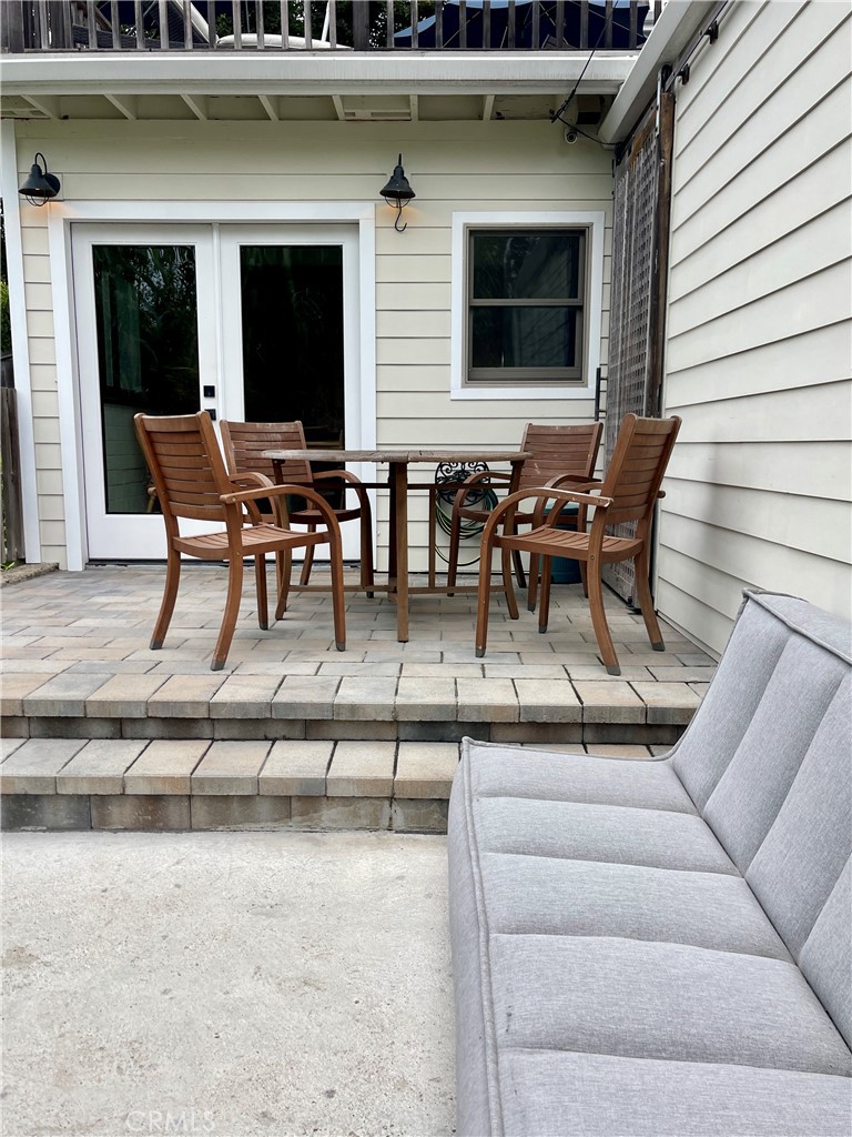 a building outdoor space with patio furniture and potted plants