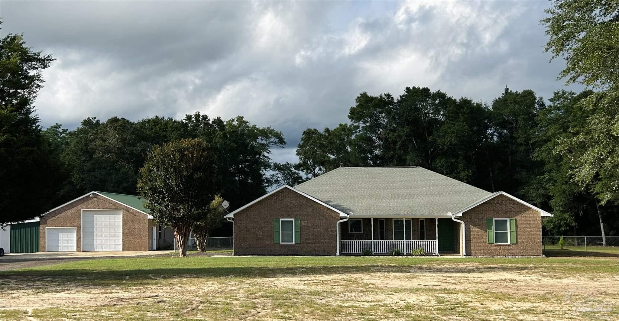 a front view of a house with a garden