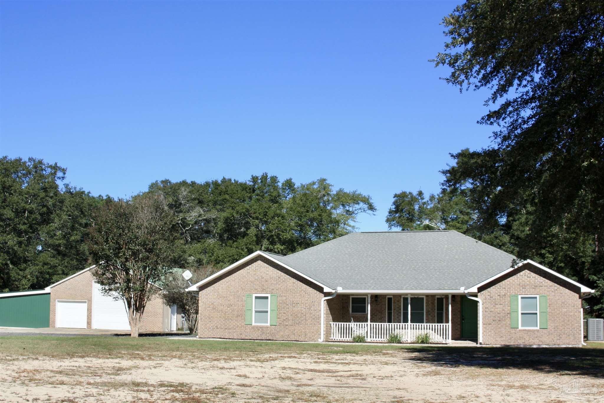 a view of house with outdoor space and swimming pool