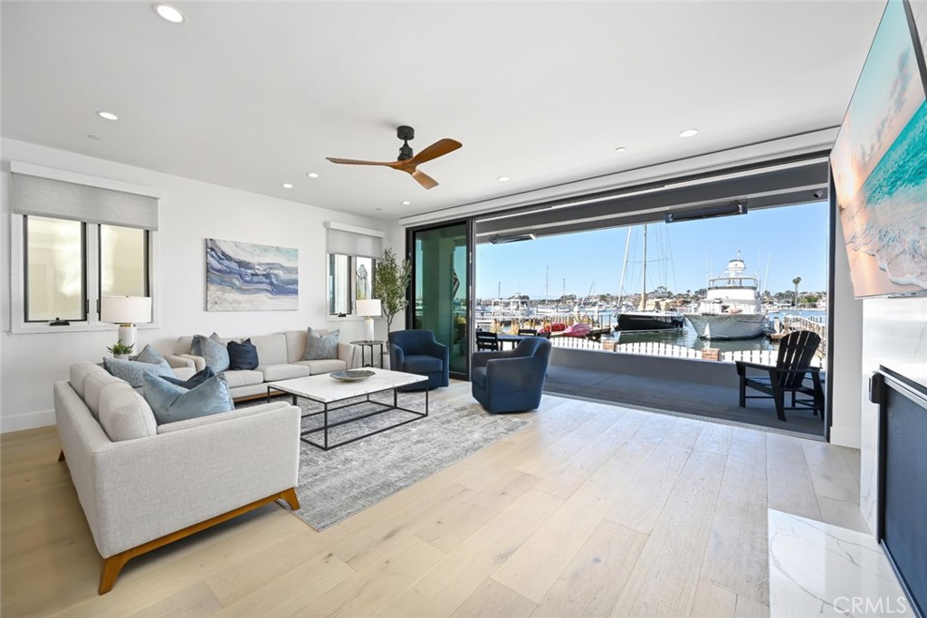 a living room with furniture kitchen view and a window