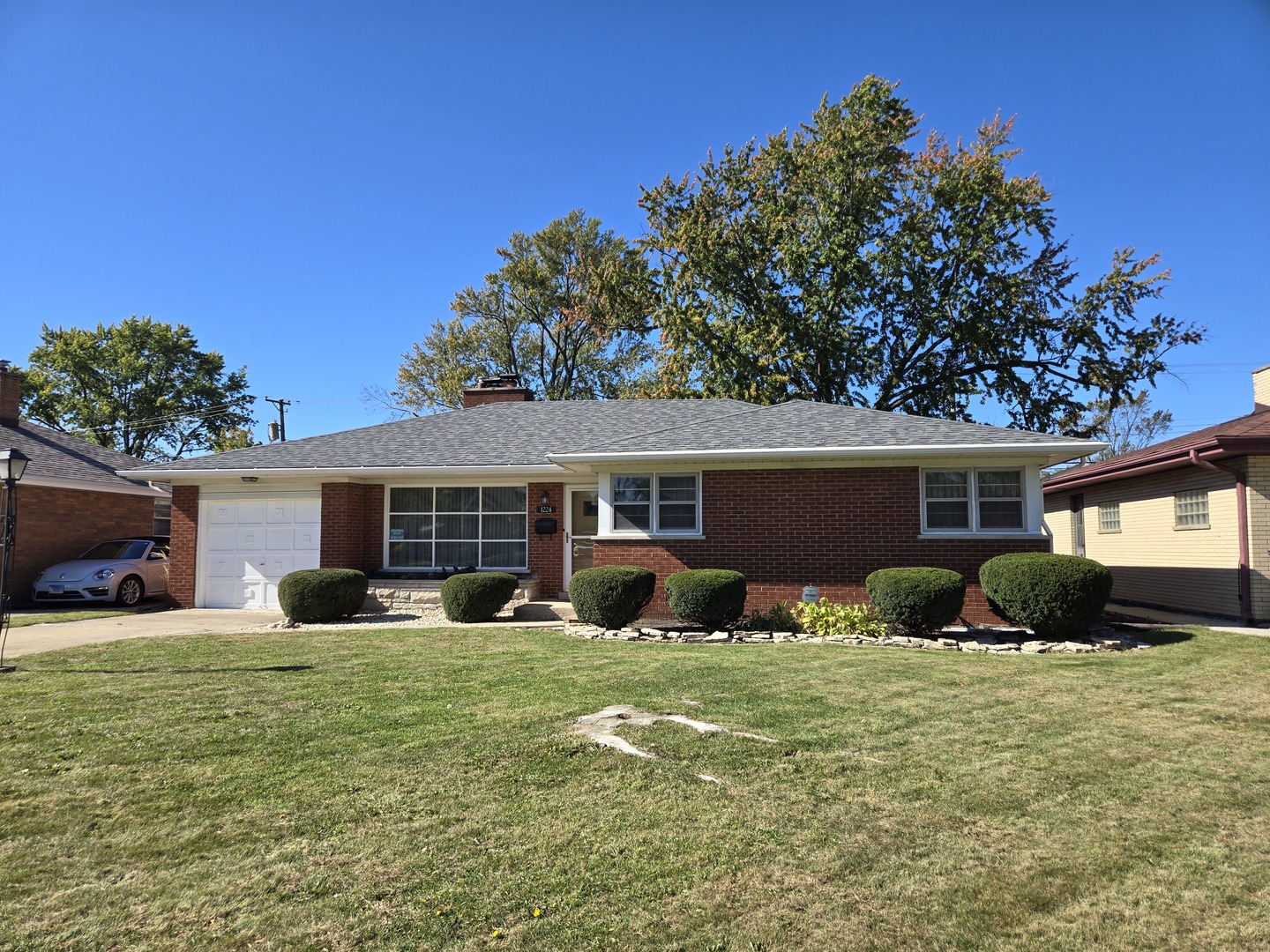 a front view of house with yard and green space