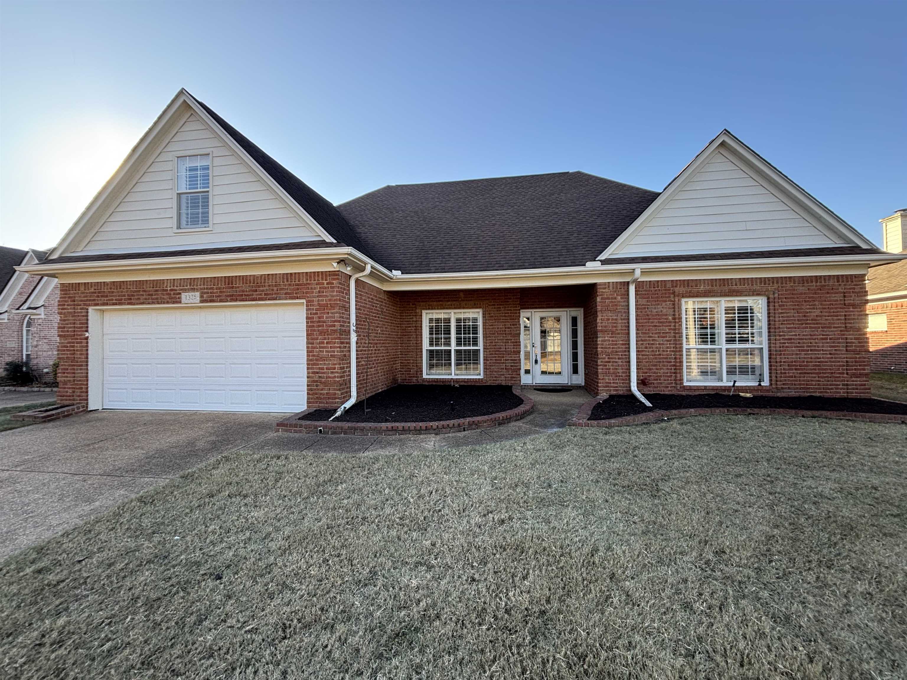 a front view of a house with a yard