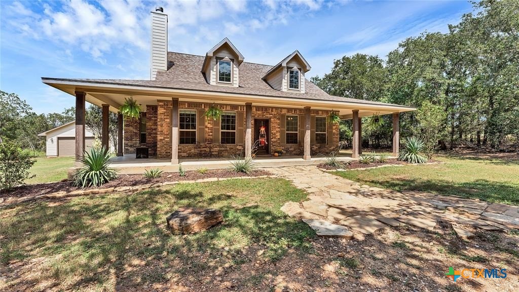 a front view of a house with a garden