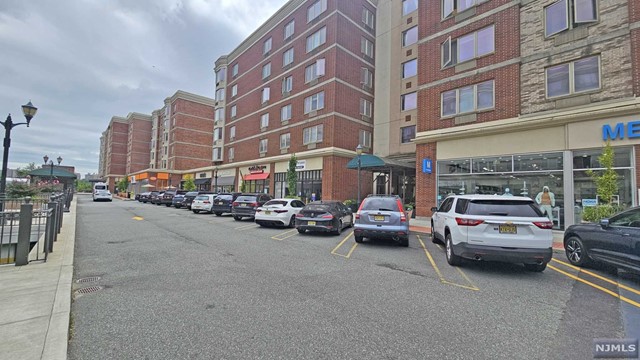 a view of a cars park in front of a building