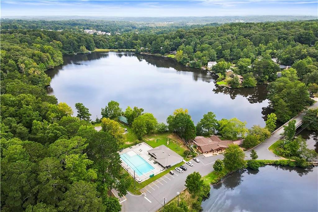 an aerial view of a house with a garden and lake view