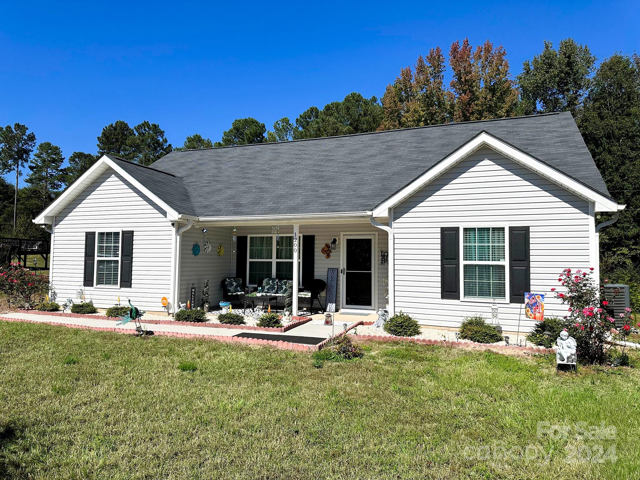 a front view of house with yard outdoor seating and green space