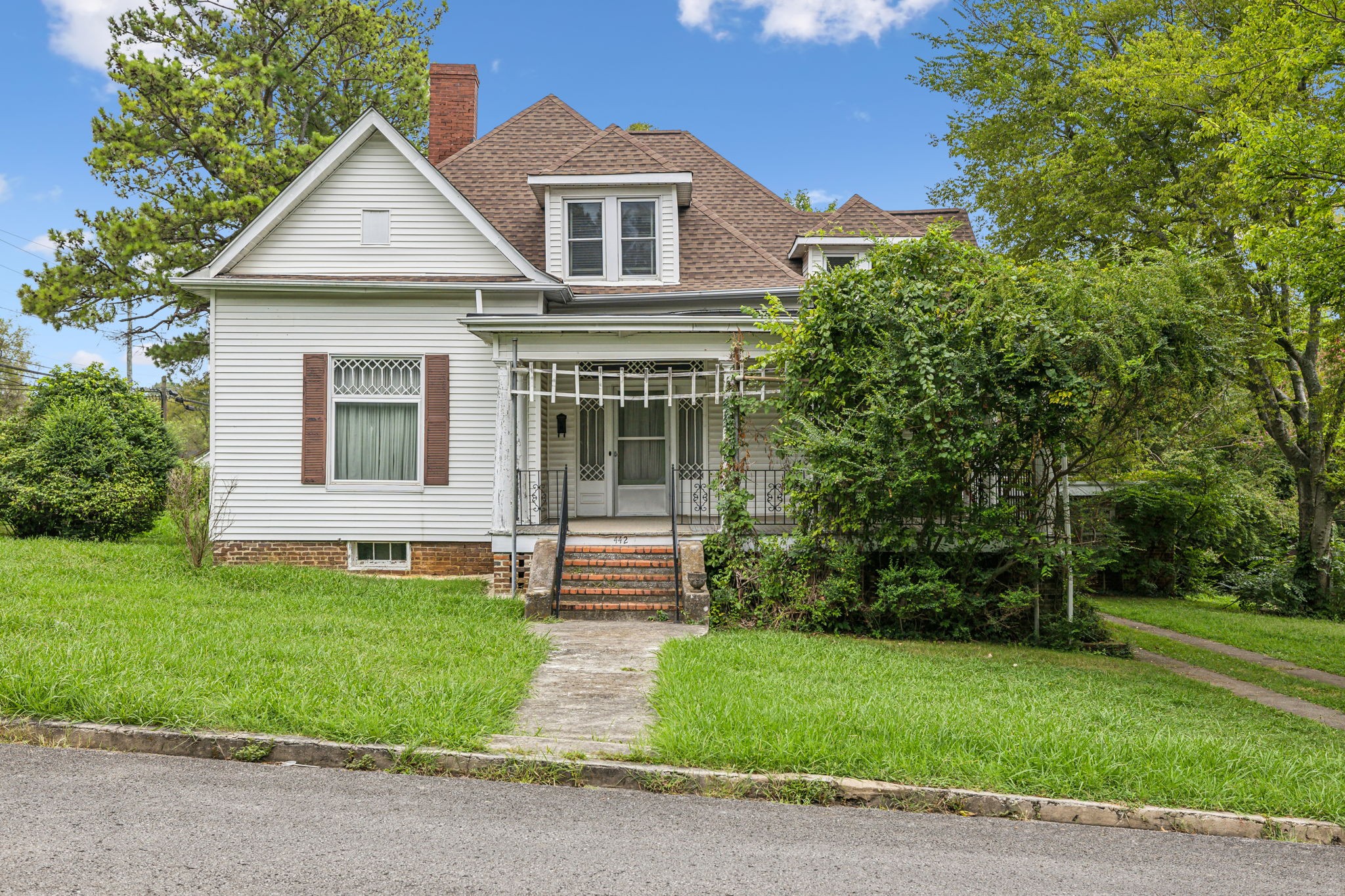 a front view of a house with a garden