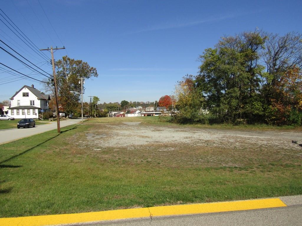 a view of yard with swimming pool and green space