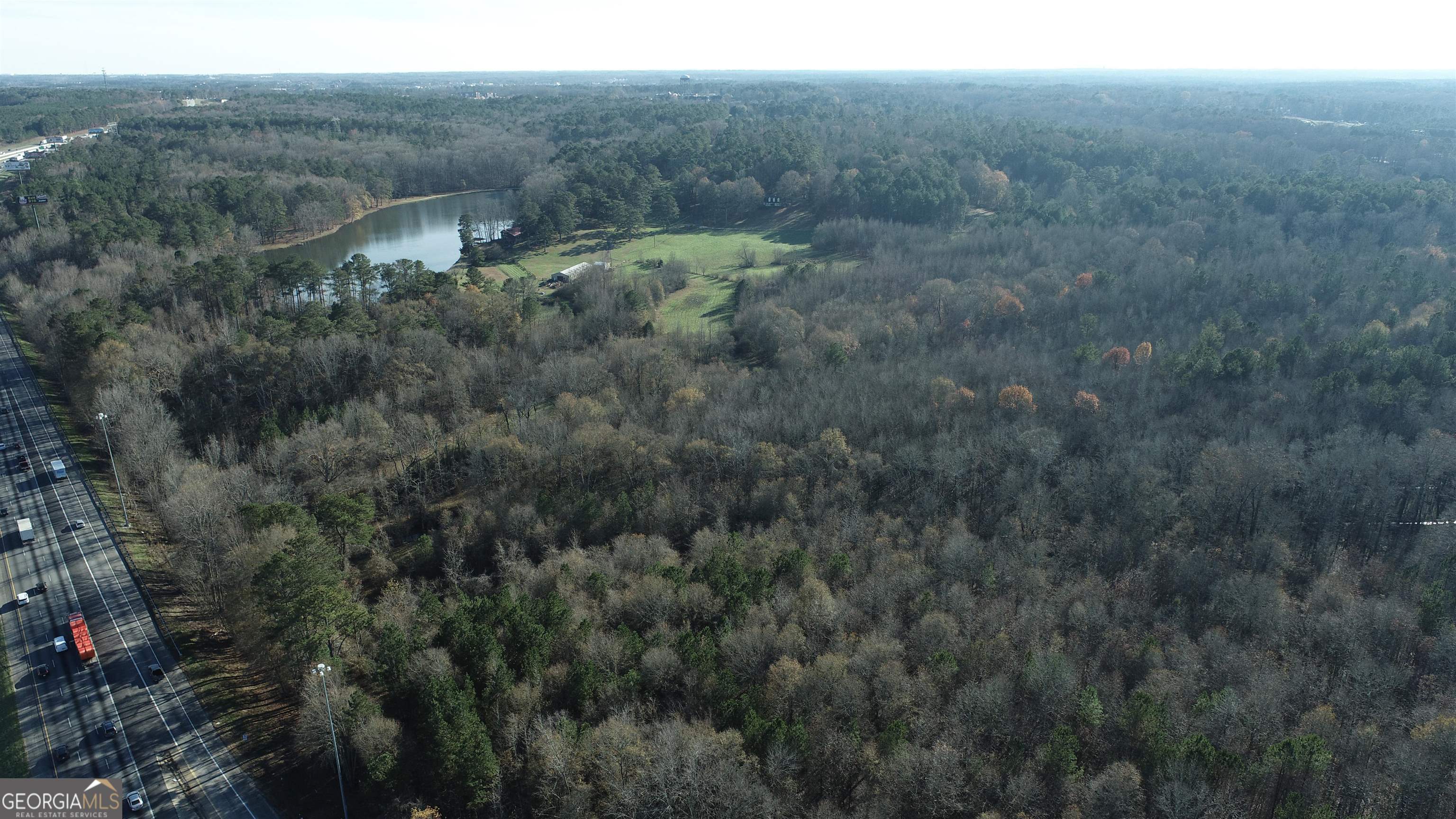 a view of a field with trees in the background