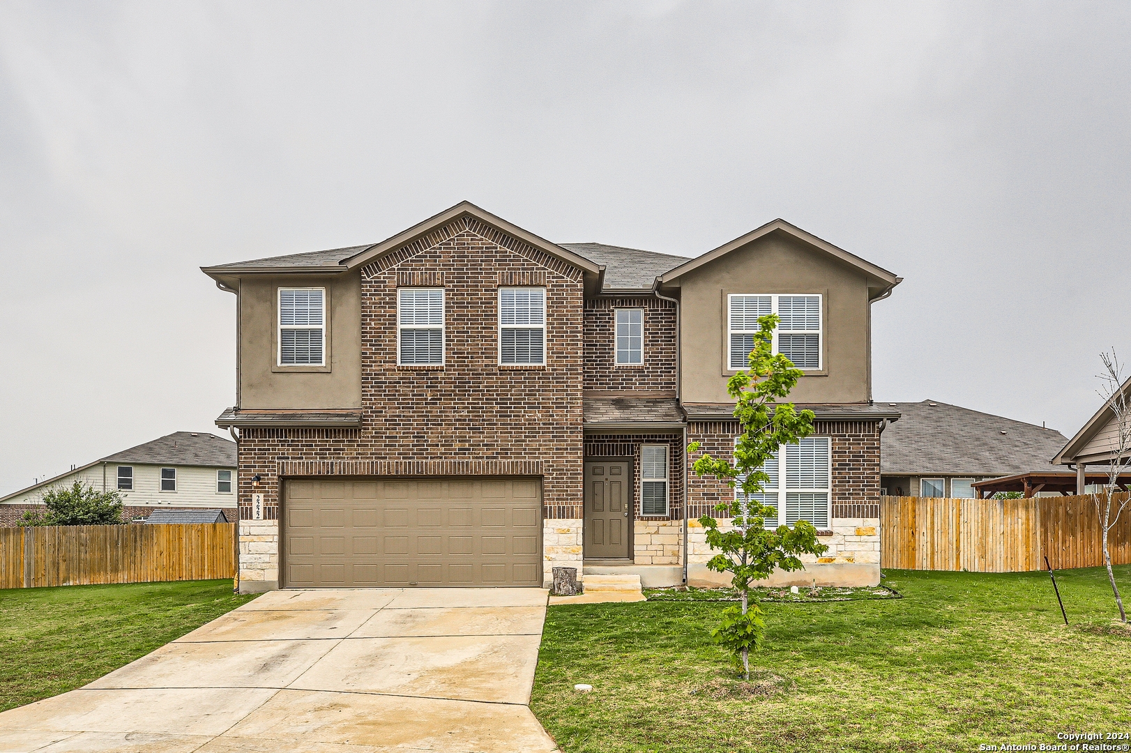 a front view of a house with a yard