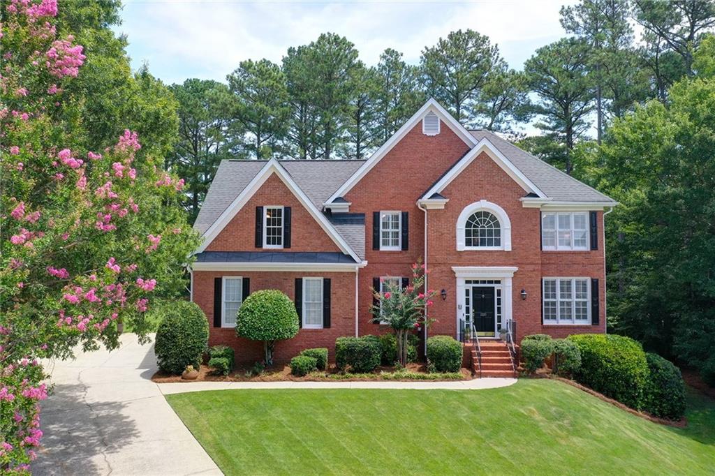 a front view of a house with garden