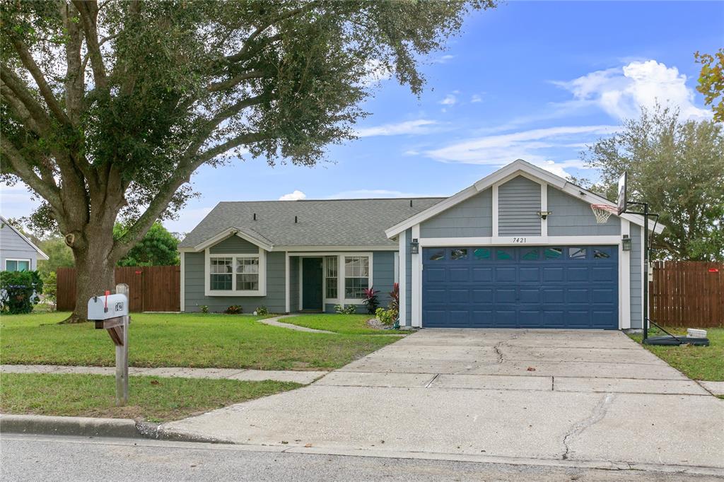 a front view of a house with a yard and trees