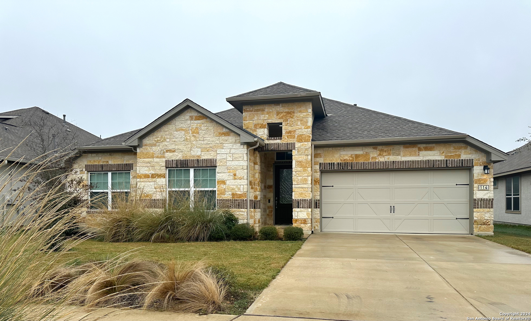 a front view of a house with a yard