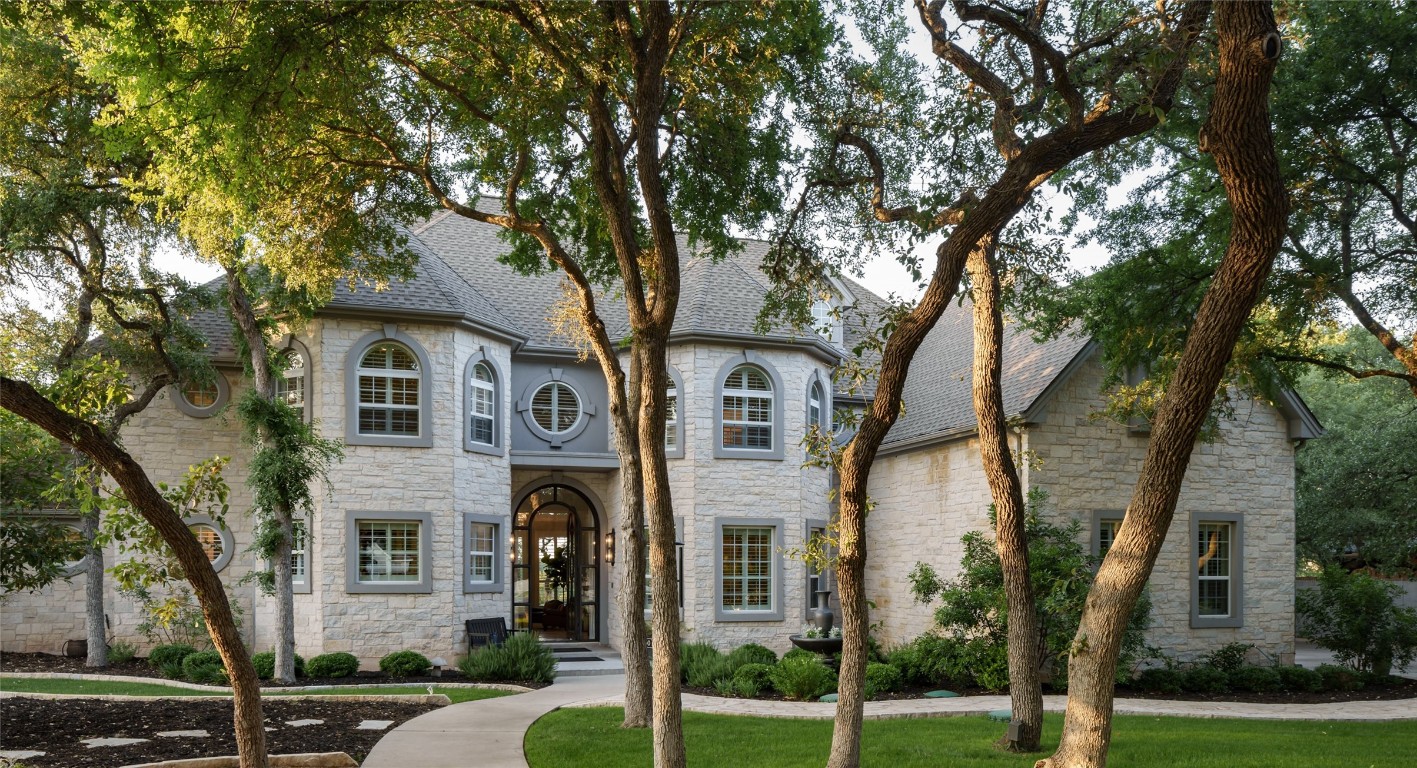 a front view of a house with a garden