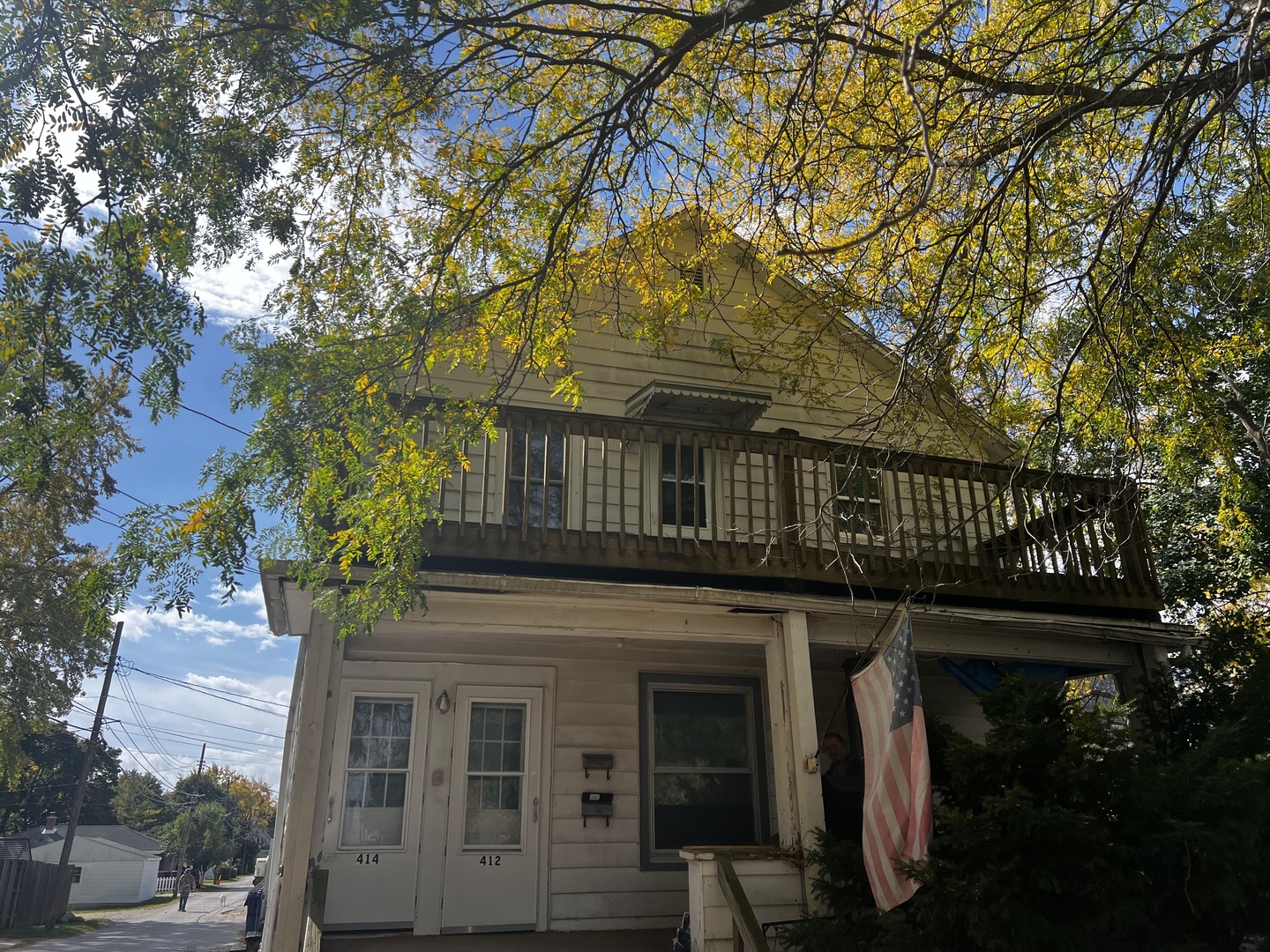 a front view of a house with a tree