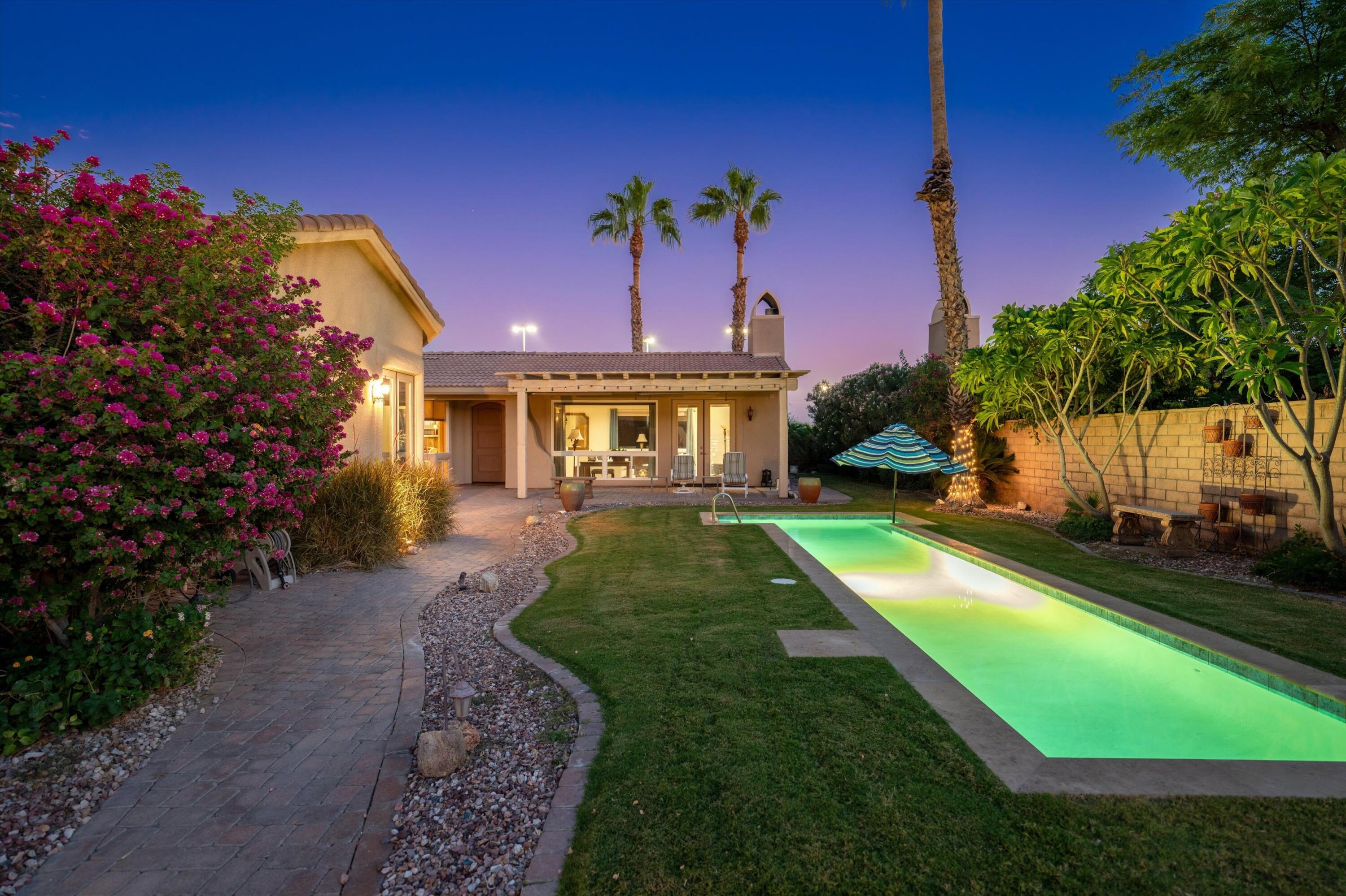 a view of a house with a backyard