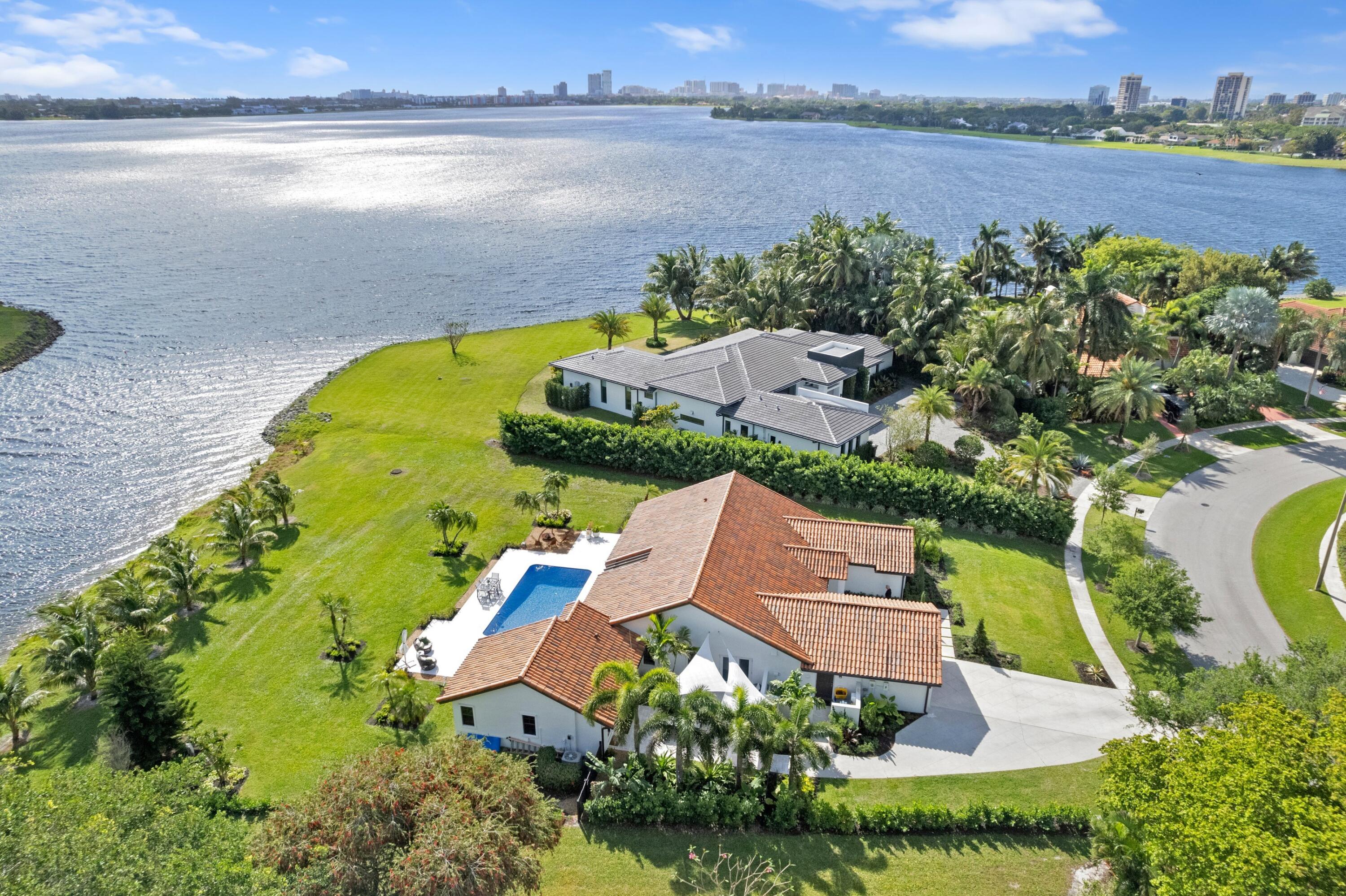 an aerial view of a house with a garden and lake view