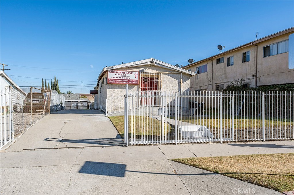 a view of a house with a wooden fence