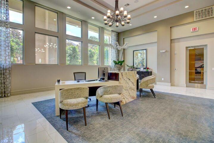 a living room with furniture a table and a large window