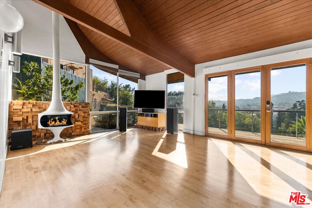 a view of a patio with a table chairs and wooden floor