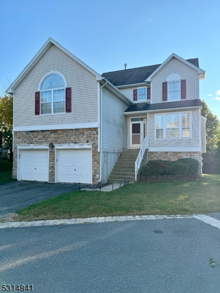 a front view of a house with a yard and garage