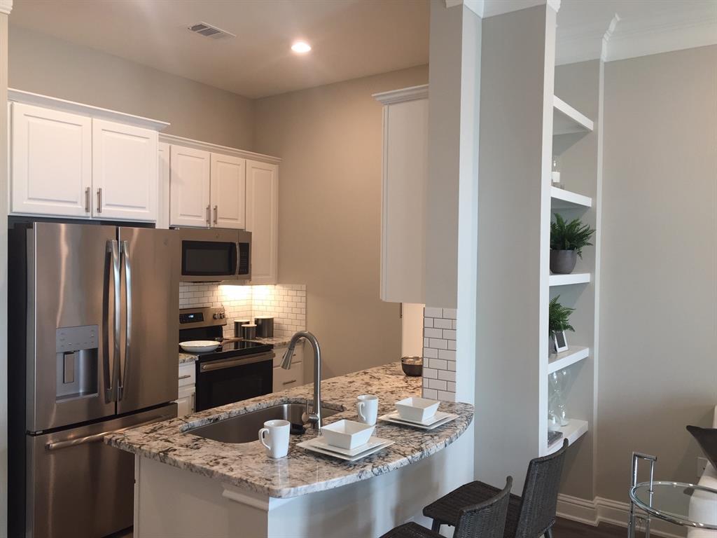 a kitchen with refrigerator and cabinets