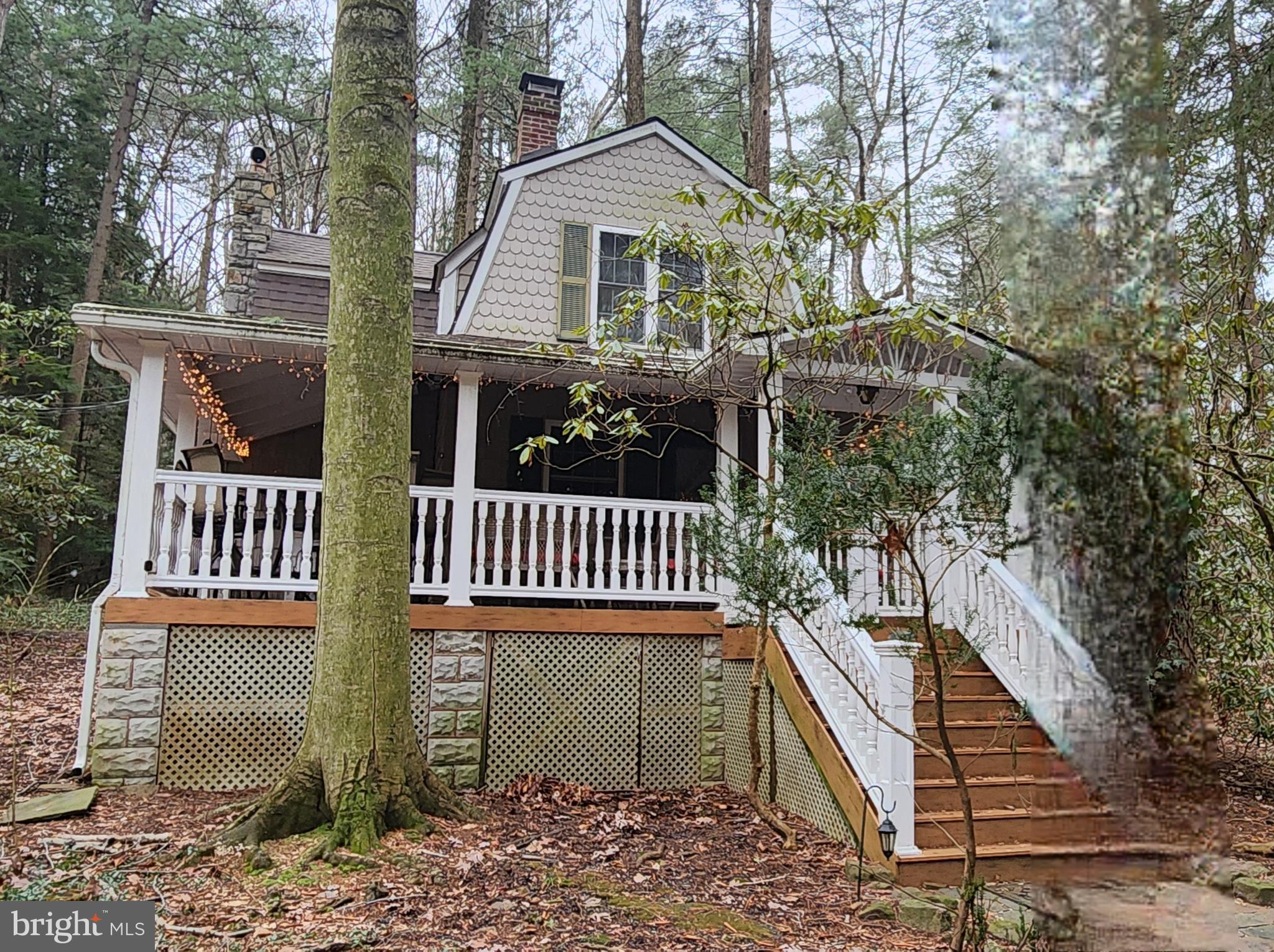 a front view of a house with deck and outdoor seating