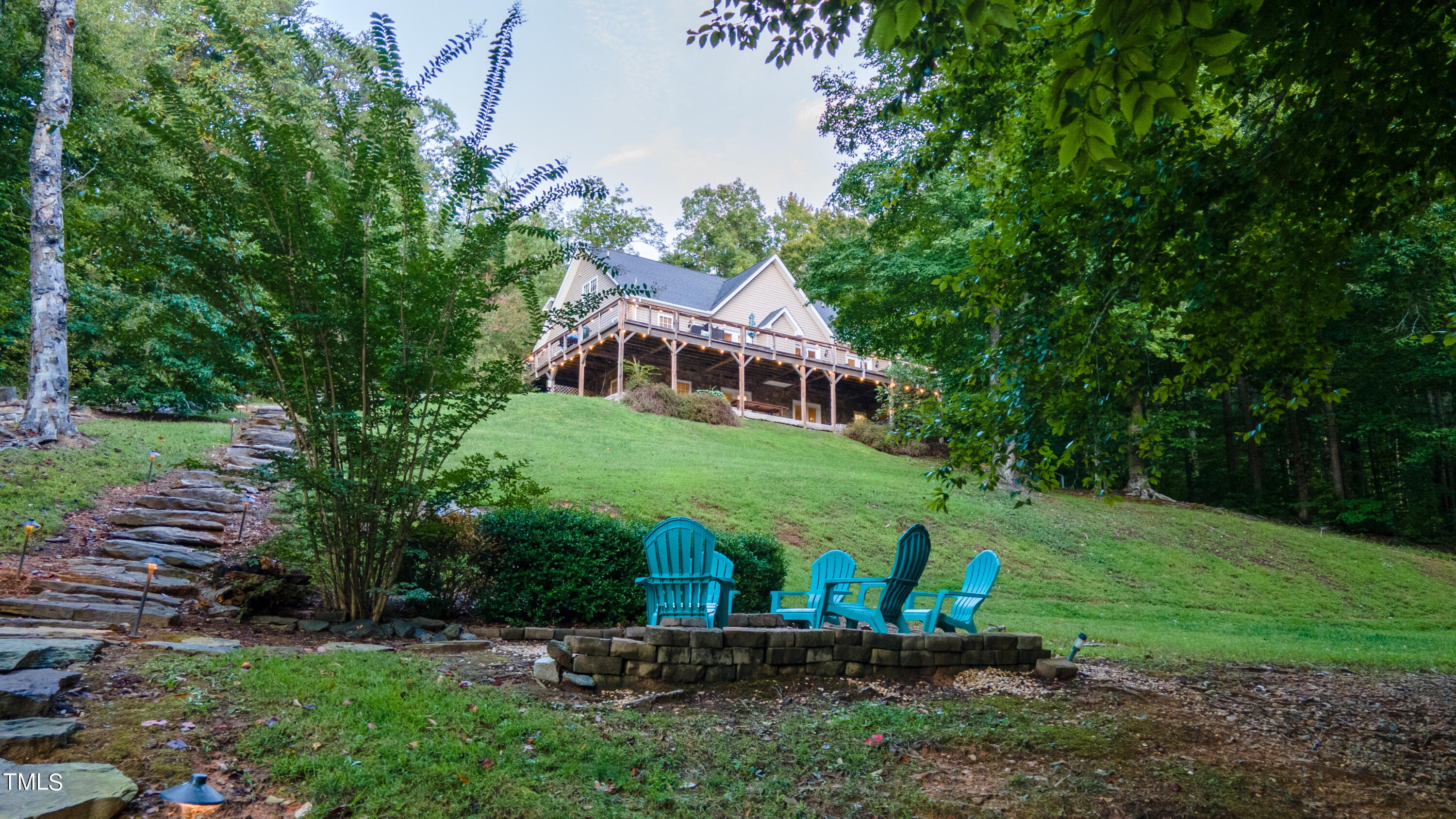 a view of a house with backyard and a sitting area