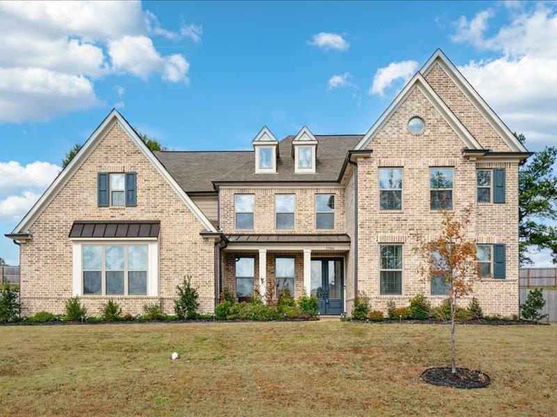 a front view of a house with a yard