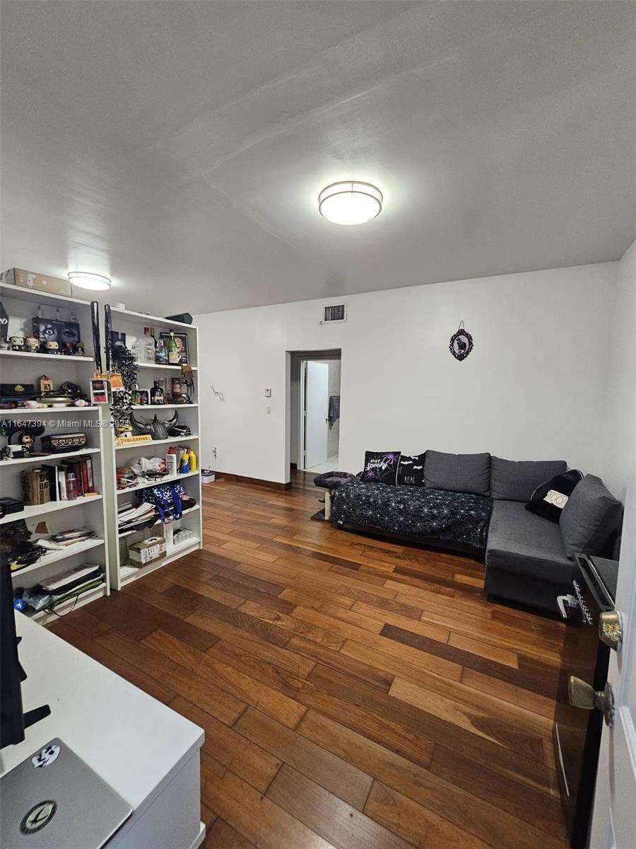 a living room with furniture and a book shelf