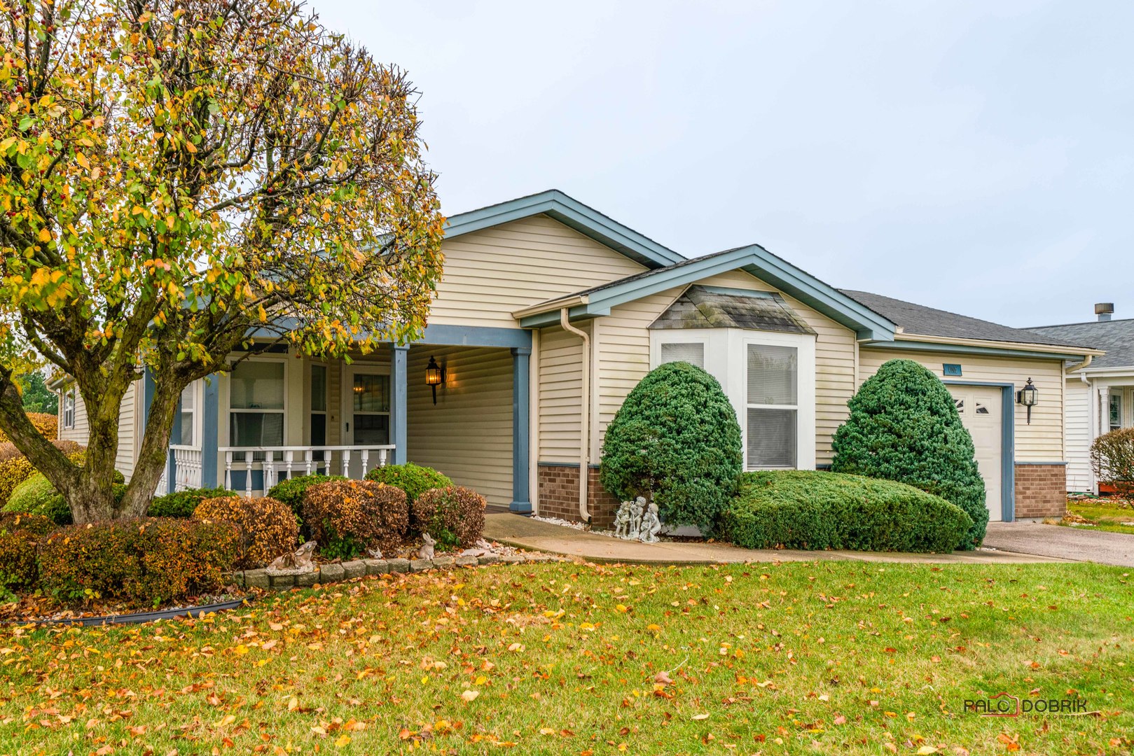 a front view of house with yard and trees around