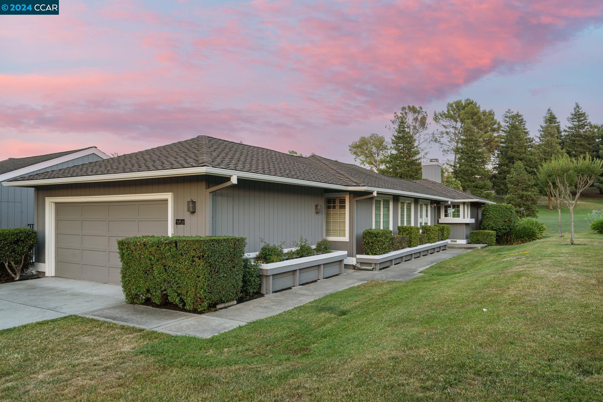 a front view of a house with garden