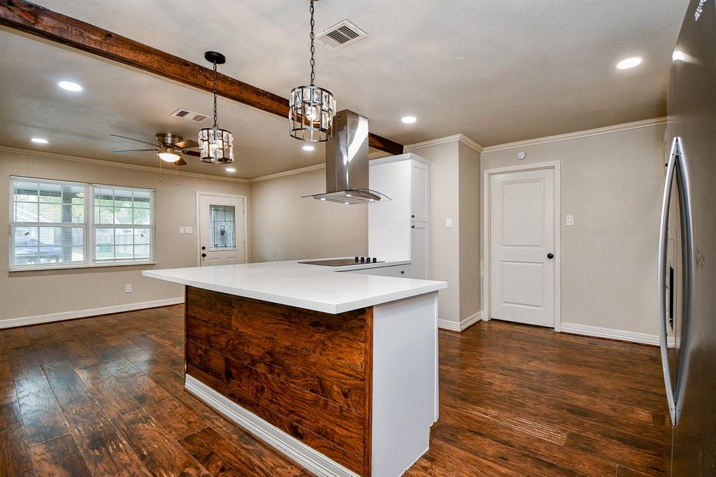 a view of a kitchen and a stove top oven