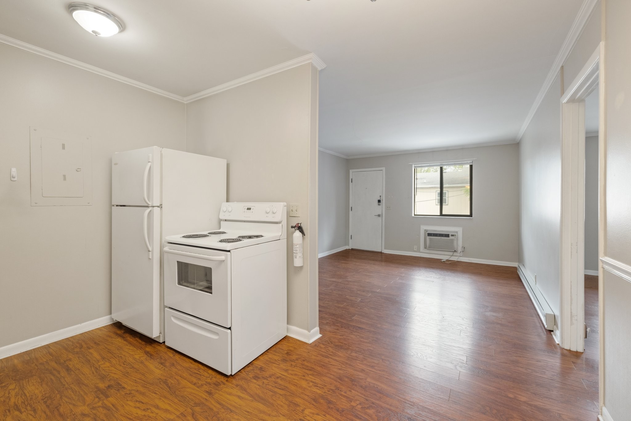 a view of a kitchen with a stove wooden floor and windows