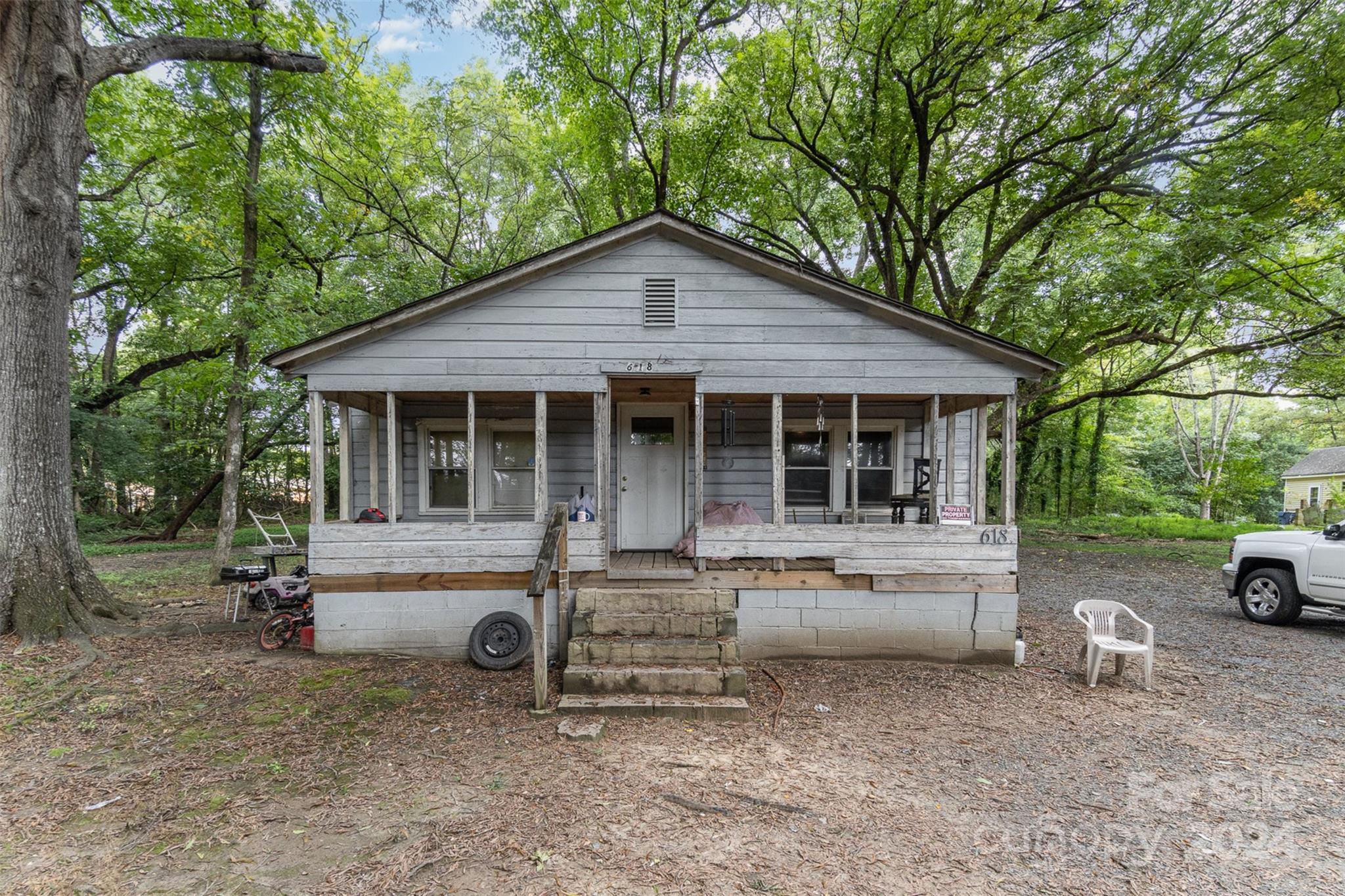 a view of a house with a yard and sitting area