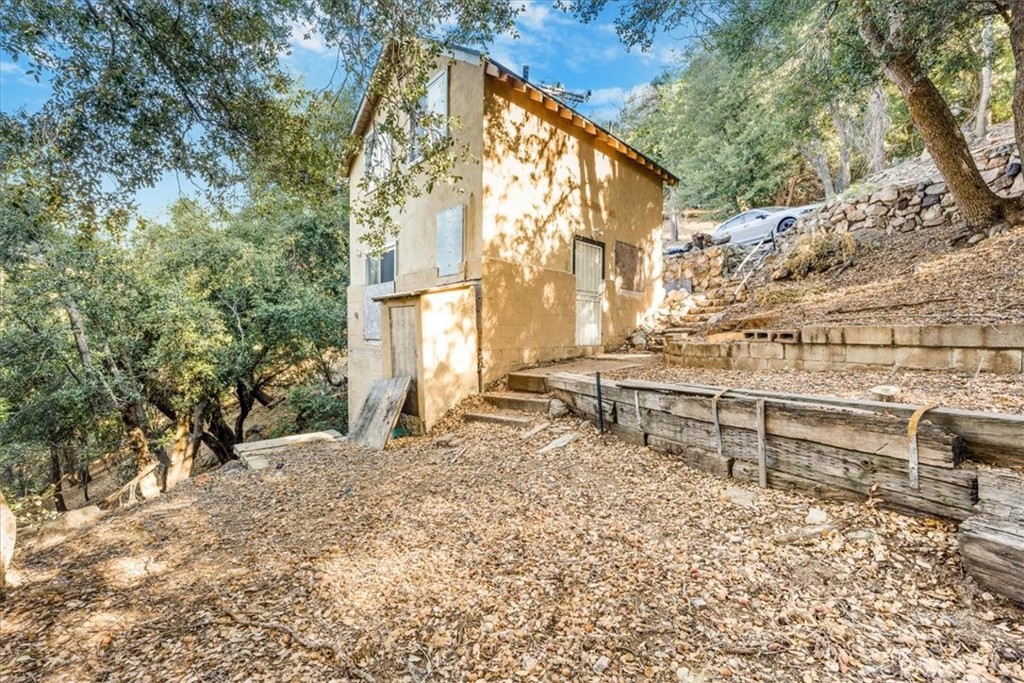 a backyard of a house with table and chairs