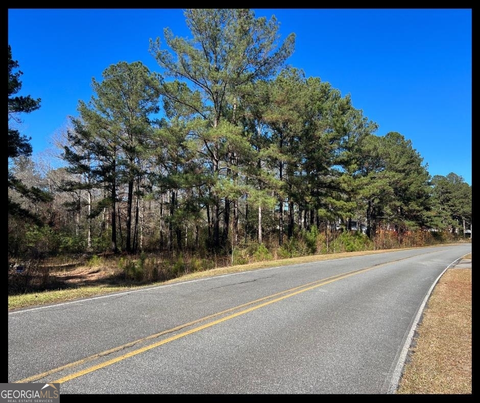 a view of a road with a building in the background