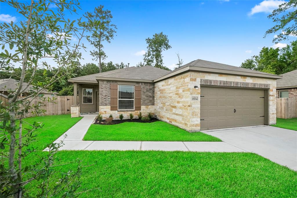 a view of a house with a yard and green space