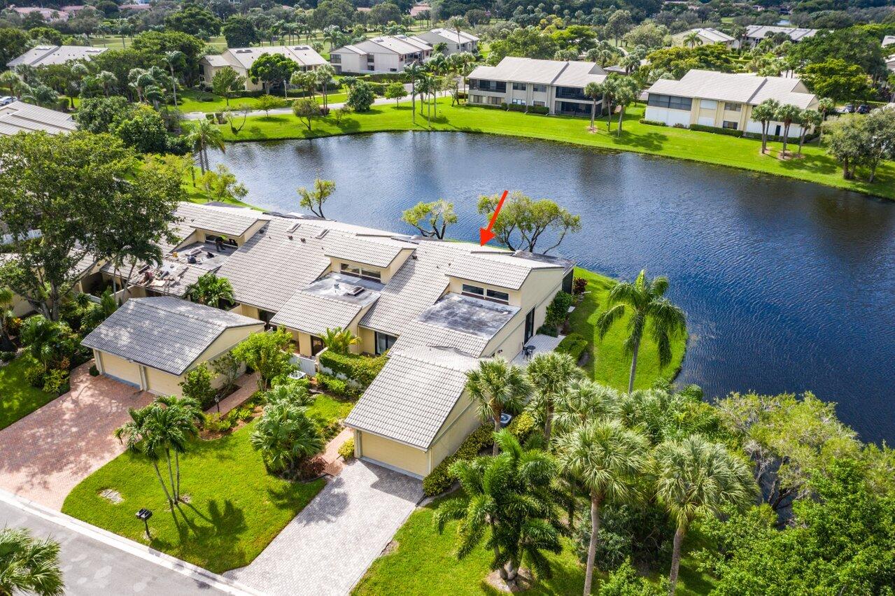 an aerial view of a house with a swimming pool patio and lake view