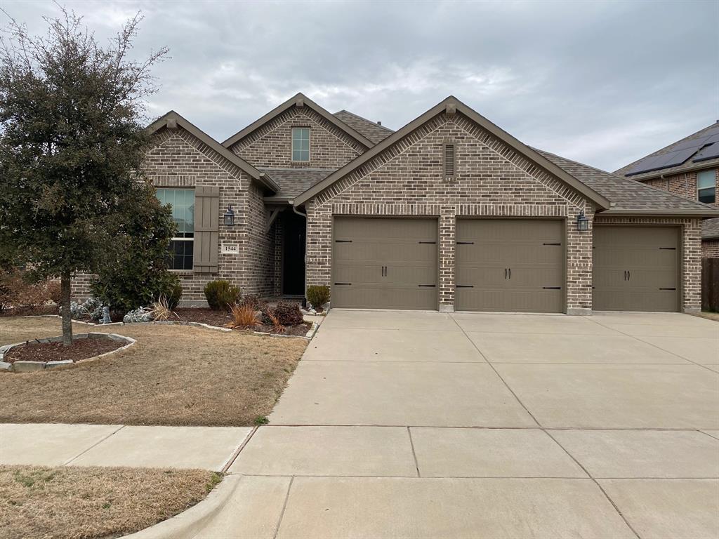 a front view of a house with yard